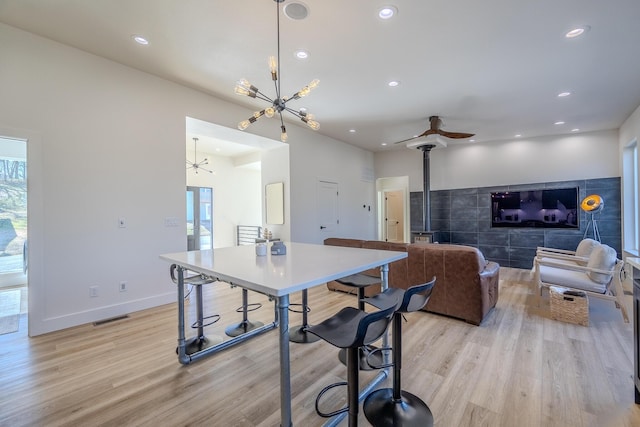139 Cherokee Dr, Kimberling City, MO 65686 - dining room featuring a chandelier, light wood-style flooring, recessed lighting, ceiling fan, and baseboards