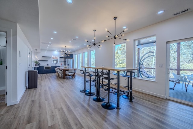 139 Cherokee Dr, Kimberling City, MO 65686 - dining space with a chandelier, wood finished floors, baseboards, and recessed lighting