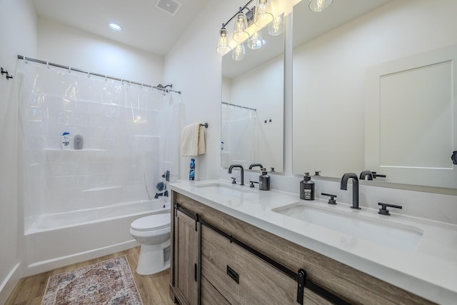 139 Cherokee Dr, Kimberling City, MO 65686 - bathroom with wood finished floors, toilet, double vanity, shower / bath combination with curtain, and recessed lighting
