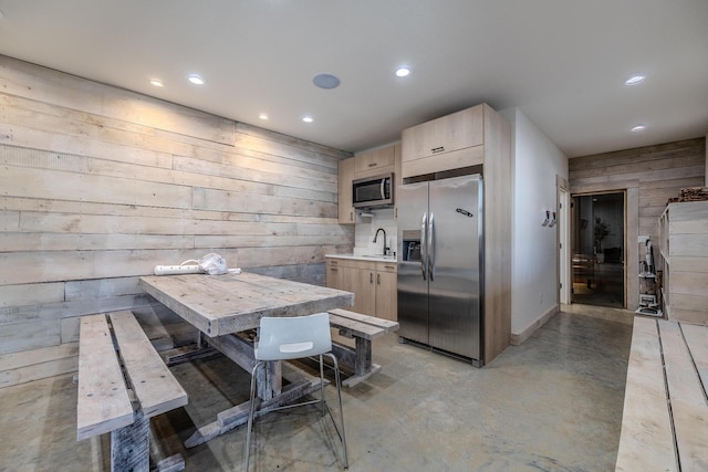 139 Cherokee Dr, Kimberling City, MO 65686 - kitchen featuring appliances with stainless steel finishes, light brown cabinets, recessed lighting, wood walls, and a sink