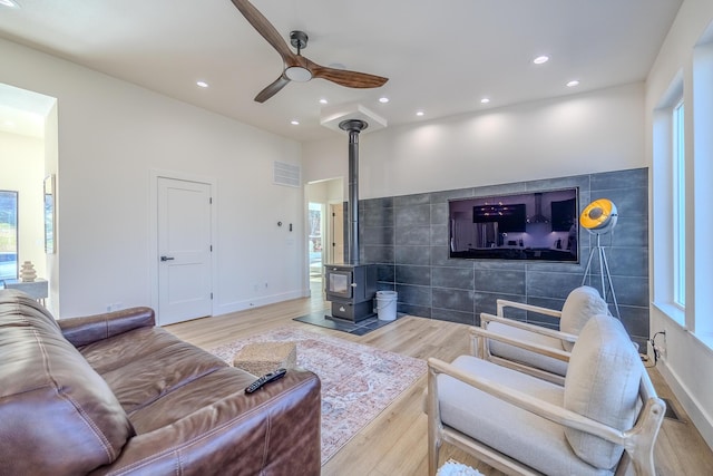 139 Cherokee Dr, Kimberling City, MO 65686 - living room with a wood stove, wood finished floors, ceiling fan, recessed lighting, and baseboards