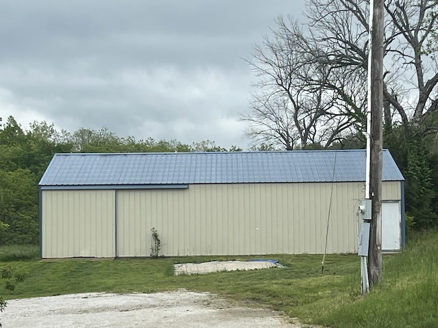 9556 N State Highway H, Pleasant Hope, MO 65725 - view of property exterior with metal roof, a pole building, an outdoor structure, and a yard