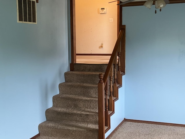 9556 N State Highway H, Pleasant Hope, MO 65725 - staircase featuring a ceiling fan, carpet, and baseboards