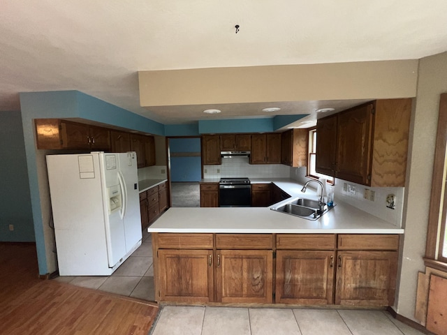 9556 N State Highway H, Pleasant Hope, MO 65725 - kitchen with white refrigerator with ice dispenser, a sink, electric range, a peninsula, and light countertops