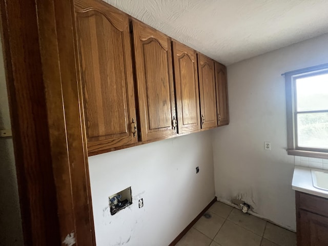9556 N State Highway H, Pleasant Hope, MO 65725 - clothes washing area with cabinet space, hookup for a washing machine, light tile patterned floors, and electric dryer hookup