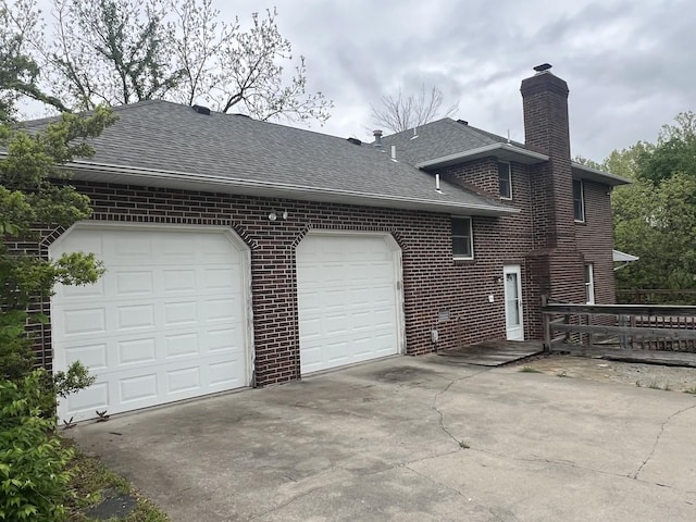 9556 N State Highway H, Pleasant Hope, MO 65725 - view of side of home featuring driveway, a chimney, a shingled roof, brick siding, and an attached garage