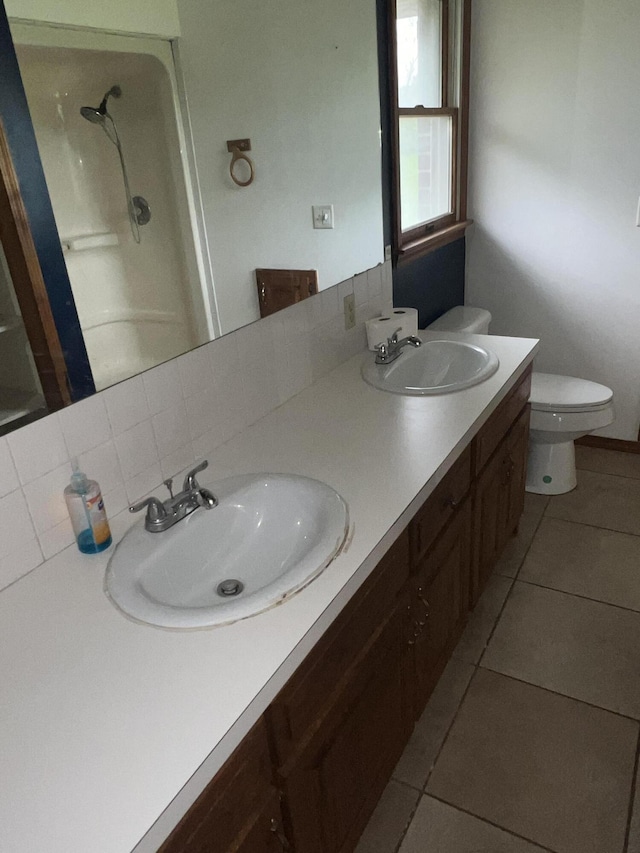9556 N State Highway H, Pleasant Hope, MO 65725 - bathroom featuring a shower, tile patterned flooring, double vanity, and toilet