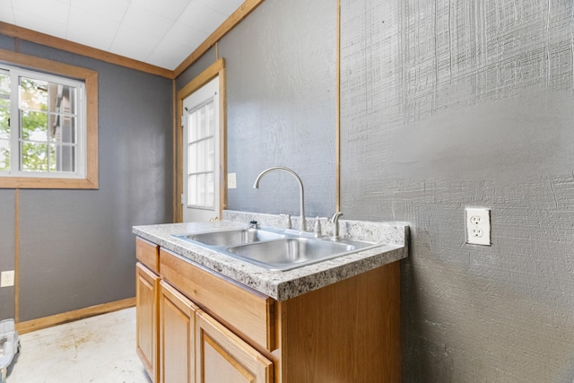 kitchen featuring a sink and baseboards