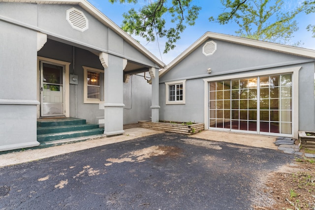 property entrance with stucco siding