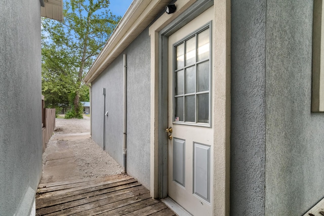 property entrance featuring stucco siding