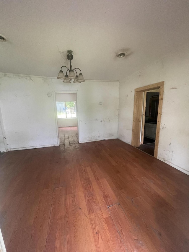 421 N Phelps St, Mansfield, MO 65704 - spare room featuring wood finished floors and a chandelier