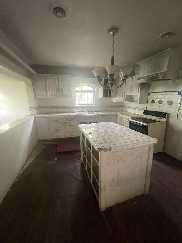 421 N Phelps St, Mansfield, MO 65704 - kitchen with tile counters, dark wood finished floors, white cabinets, and a chandelier