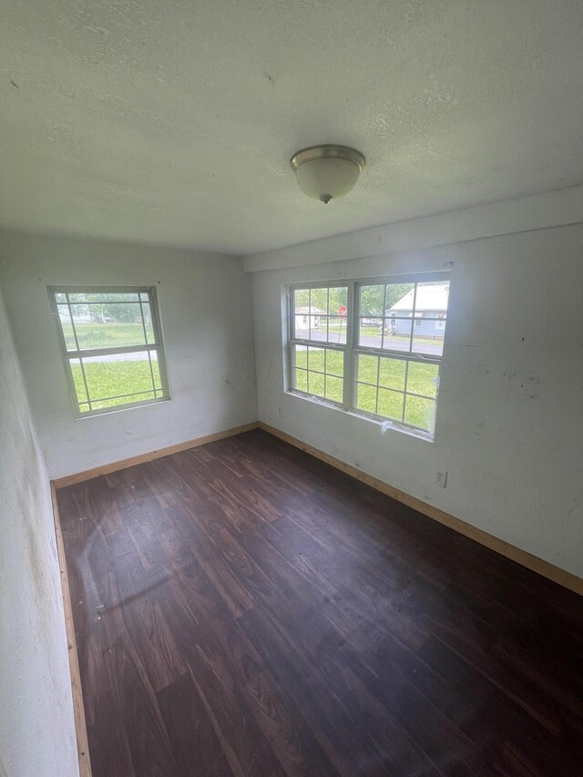 421 N Phelps St, Mansfield, MO 65704 - spare room with dark wood finished floors, a textured ceiling, and baseboards