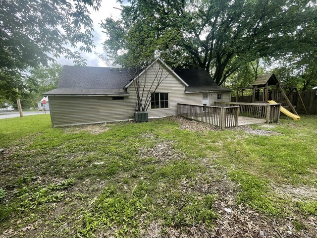 421 N Phelps St, Mansfield, MO 65704 - rear view of property featuring a playground, a deck, and central air condition unit
