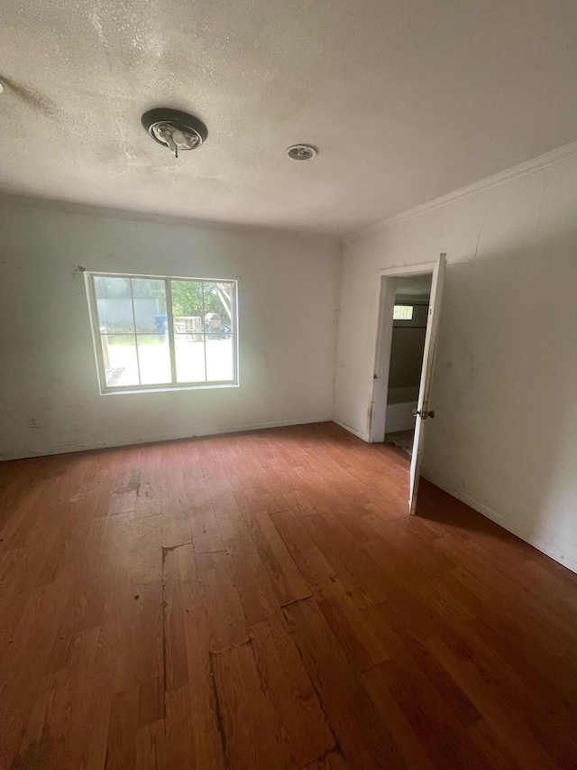 421 N Phelps St, Mansfield, MO 65704 - spare room with wood finished floors and a textured ceiling