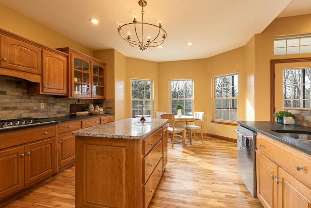 143 Woodfield Dr, Highlandville, MO 65669 - kitchen featuring gas cooktop, light wood-style flooring, dishwasher, a chandelier, and brown cabinetry