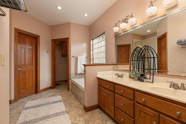 143 Woodfield Dr, Highlandville, MO 65669 - full bath featuring a bath, double vanity, recessed lighting, and baseboards