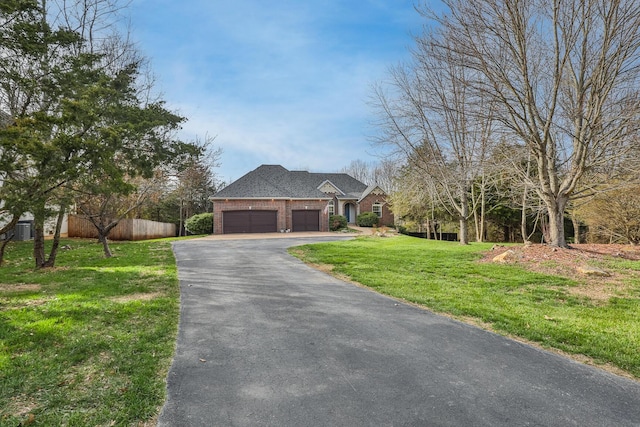143 Woodfield Dr, Highlandville, MO 65669 - view of front of property with asphalt driveway, an attached garage, and brick siding