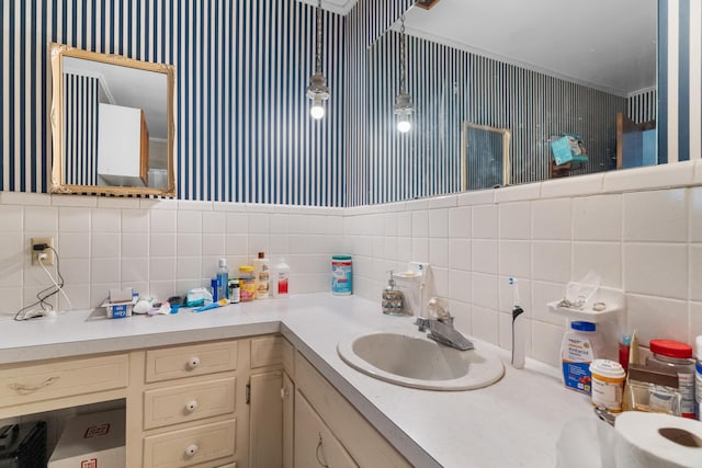 bathroom featuring tasteful backsplash, crown molding, and vanity