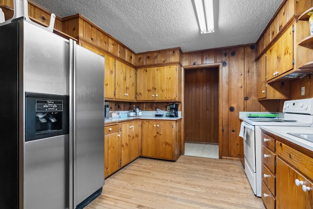 kitchen with stainless steel refrigerator with ice dispenser, electric range, light countertops, open shelves, and a textured ceiling