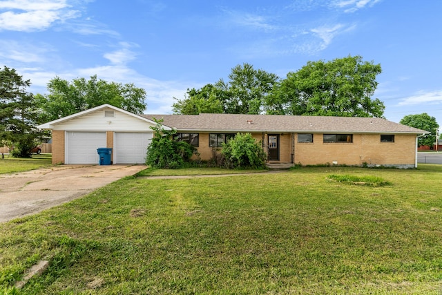 ranch-style home with brick siding, a garage, concrete driveway, and a front yard