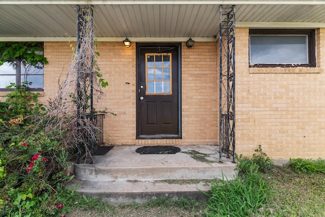 property entrance with brick siding