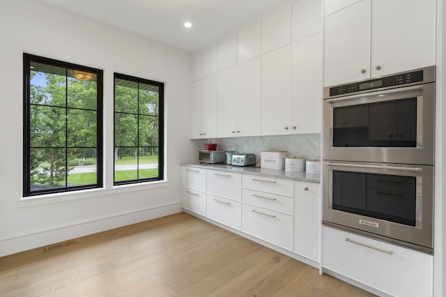 273 Secret Ln, Branson West, MO 65737 - kitchen with double oven, decorative backsplash, white cabinetry, light wood-style flooring, and recessed lighting