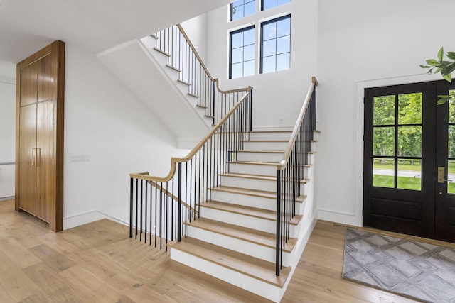273 Secret Ln, Branson West, MO 65737 - foyer with light wood finished floors, healthy amount of natural light, stairway, a towering ceiling, and baseboards