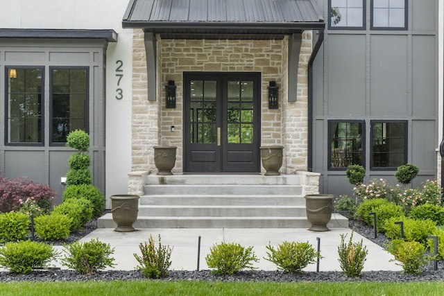 273 Secret Ln, Branson West, MO 65737 - entrance to property with french doors, stone siding, and metal roof