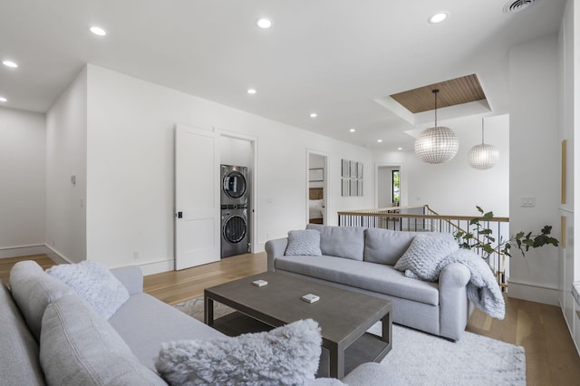273 Secret Ln, Branson West, MO 65737 - living area featuring estacked washer and dryer, wood finished floors, recessed lighting, and baseboards