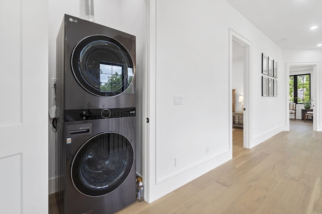 273 Secret Ln, Branson West, MO 65737 - clothes washing area with stacked washing machine and dryer, wood finished floors, recessed lighting, and baseboards