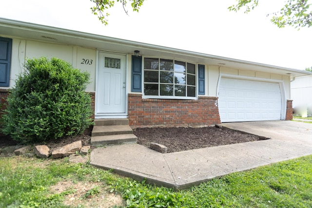 view of front of home with brick siding, an attached garage, concrete driveway, and entry steps