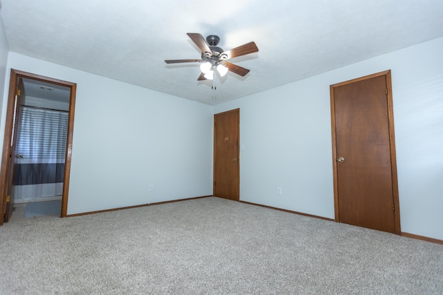 empty room featuring ceiling fan, carpet flooring, and baseboards