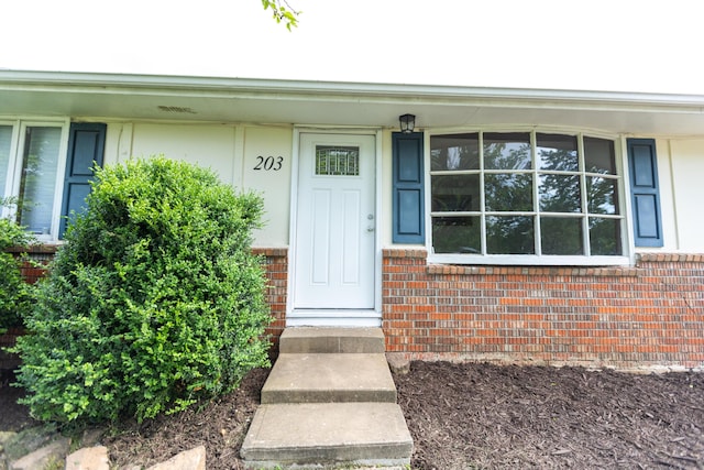 entrance to property with brick siding
