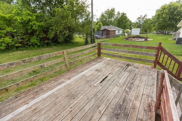 wooden deck featuring a yard