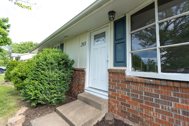 property entrance with brick siding