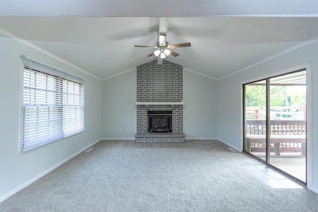 unfurnished living room with ceiling fan, carpet floors, crown molding, baseboards, and a fireplace
