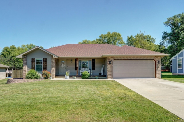 311 W Hayes Rd, Clever, MO 65631 - ranch-style house featuring an attached garage, driveway, covered porch, and brick siding