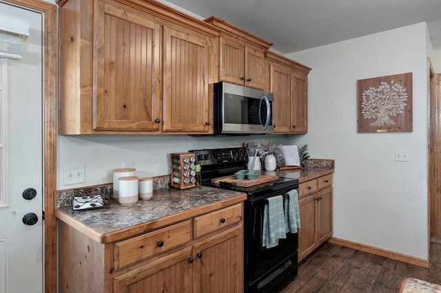 311 W Hayes Rd, Clever, MO 65631 - kitchen featuring black / electric stove, stainless steel microwave, dark wood-type flooring, dark countertops, and brown cabinetry