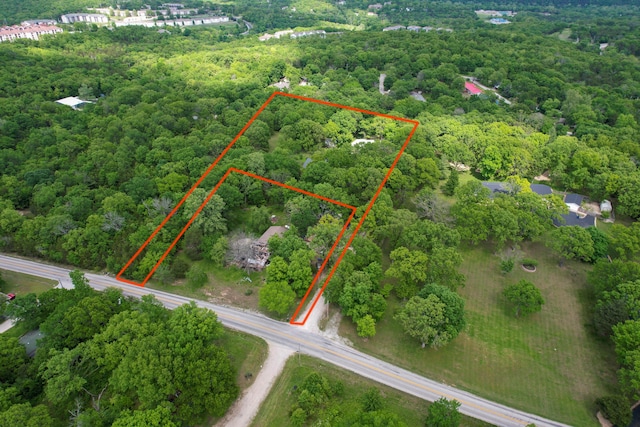 aerial overview of property's location featuring property boundaries highlighted and a heavily wooded area