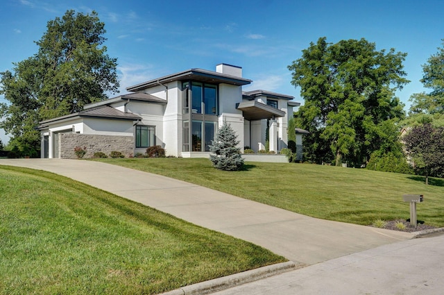 3900 E Dunrobin Dr, Springfield, MO 65809 - modern home with a chimney, a front yard, driveway, stone siding, and an attached garage