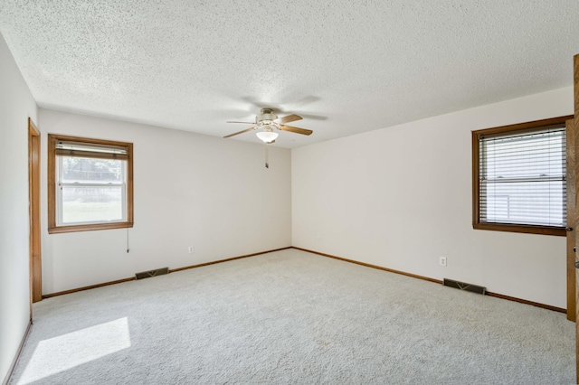4852 S Charleston Ave, Springfield, MO 65804 - carpeted empty room featuring a ceiling fan, a textured ceiling, and baseboards