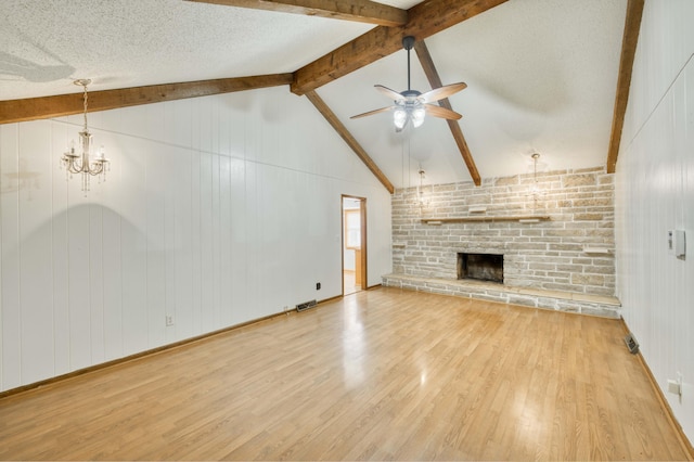 4852 S Charleston Ave, Springfield, MO 65804 - unfurnished living room featuring wood finished floors, a fireplace, a ceiling fan, and a chandelier