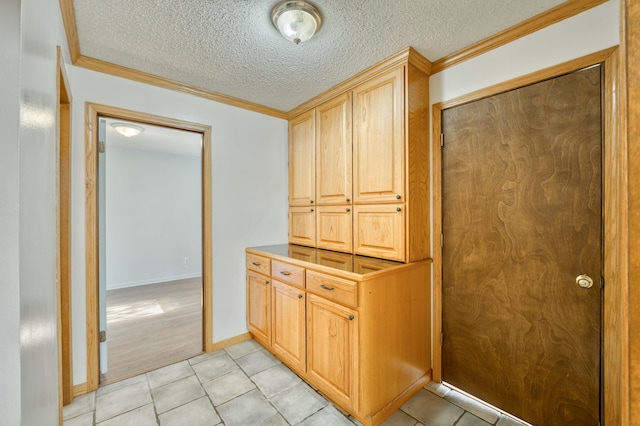 4852 S Charleston Ave, Springfield, MO 65804 - corridor featuring crown molding, light tile patterned floors, a textured ceiling, and baseboards