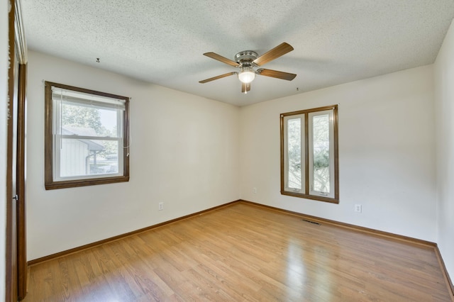 4852 S Charleston Ave, Springfield, MO 65804 - spare room featuring light wood-type flooring, a textured ceiling, ceiling fan, and baseboards