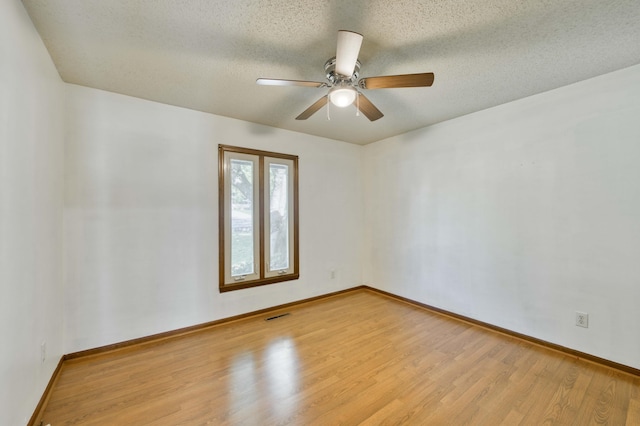 4852 S Charleston Ave, Springfield, MO 65804 - empty room featuring wood finished floors, a ceiling fan, baseboards, and a textured ceiling