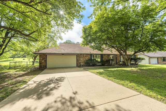 4852 S Charleston Ave, Springfield, MO 65804 - view of front of property with an attached garage, driveway, and stone siding