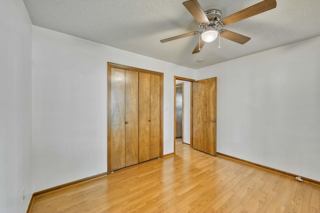 4852 S Charleston Ave, Springfield, MO 65804 - unfurnished bedroom with baseboards, light wood-style flooring, a closet, a textured ceiling, and a ceiling fan