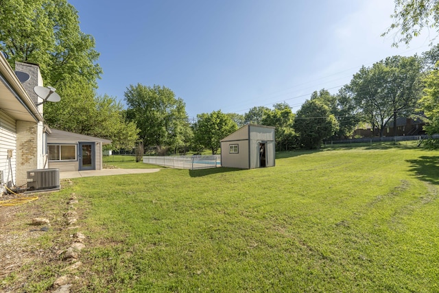4852 S Charleston Ave, Springfield, MO 65804 - view of yard featuring central AC unit, a patio, an outdoor structure, and a storage unit