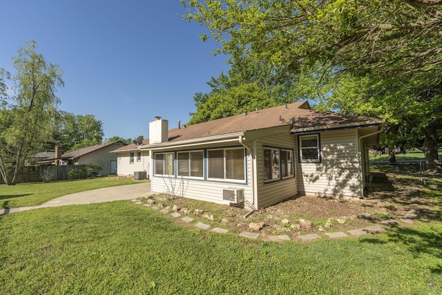 4852 S Charleston Ave, Springfield, MO 65804 - rear view of property featuring a chimney, a patio, and cooling unit